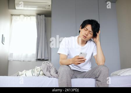 Japanese man waking up Stock Photo