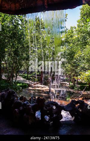 Water stream of a small waterfall and landscape on background in Turkey Stock Photo