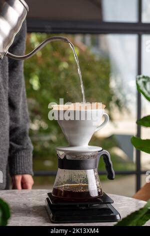 Heating up espresso coffee in a Cuban coffee maker using a mini gas stove  with a Coleman propane tank on a single burner. A thunderstorm is  approaching Stock Photo - Alamy