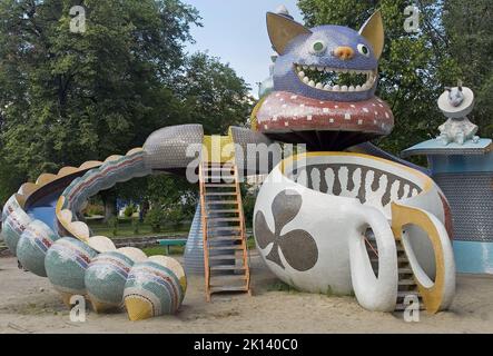 Children's playground slide depicting Mad tea party of Alice's Adventures in Wonderland, at Pejzazhna alley, the famous children's park in Kiev, Ukrai Stock Photo