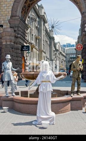 Three unidentified busking mimes perform on Khreshchatyk street in Kiev, Ukraine Stock Photo