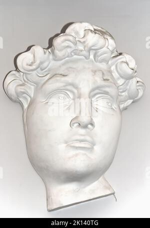 Young Greek man plaster head model to learn to draw head on fine art lessons at studio Stock Photo