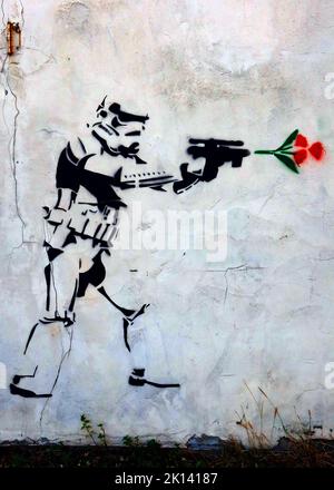 Stormtrooper fires a gun and a red rose comes out, stencil art in Church Street, Runcorn, Halton, Cheshire, England, UK, WA7 1LR Stock Photo