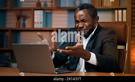 Upset businessman working on laptop making mistake losing important data due to system failure frustrated annoyed man receives notification reads bad Stock Photo