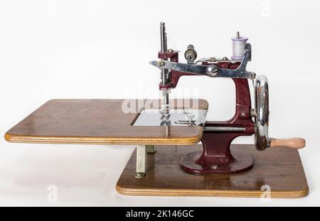 Antique Toy Sewing Machine isolated on white Stock Photo
