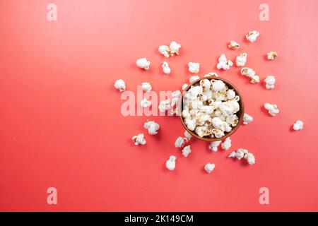 popcorn in a bowl on red background top view  Stock Photo