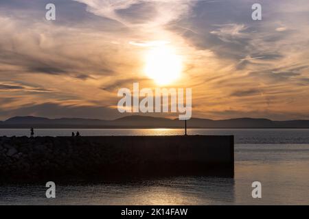 Beautiful sunset on Riviere-du-Loup pier. Colorful cloudy sky. Stock Photo