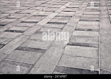 New paving made with stone blocks of rectangular shape in a pedestrian zone. Stock Photo