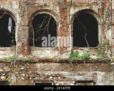 Arched window openings of a destroyed abandoned building. Broken ...