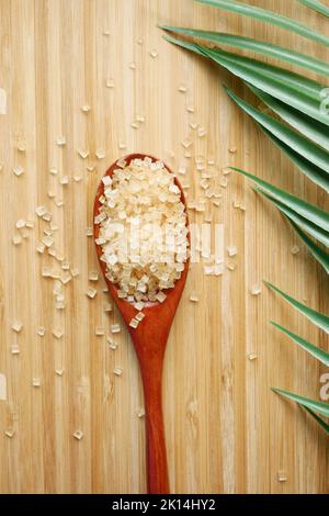 crystal brown sugar brown on a wooden spoon on table  Stock Photo