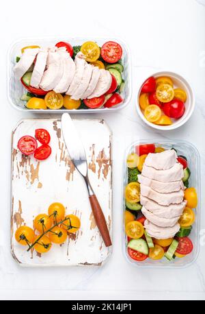 Meal prep lunch boxes containers with chicken and salad top view Stock Photo