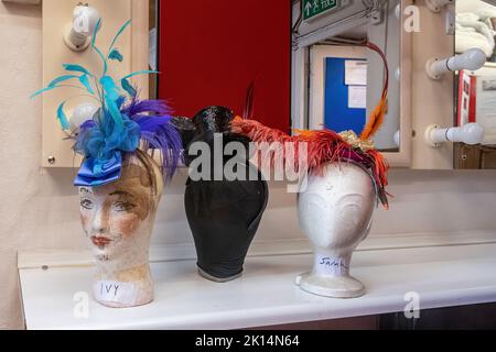 Chesil Theatre, in the former 12th century church of St Peter Chesil, in Winchester, Hampshire, UK. Mannequin heads with hats in the dressing room. Stock Photo