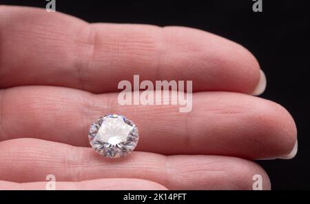 Big Carat Diamond Gemstone on Female Hand Stock Photo