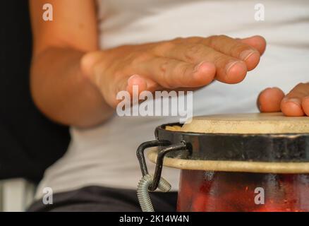 African drum workshop. Person playing a djembe with his hands. Aerial view. selective focus Stock Photo