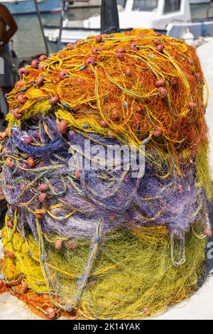 Close up of a pile of colourful fishing nets - Vlichada marina / port, Santorini, Cyclades islands, Greece, Europe Stock Photo