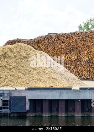 Large pile with logs and wood chips, sustainable renewable heat energy ...
