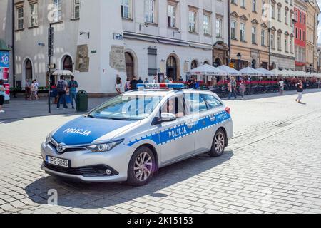 A police car on patrol at the market square at Krakow Old Town Poland Stock Photo