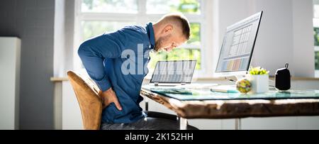 Man With Back Pain. Bad Office Posture Stock Photo