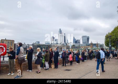 London, UK. 15th Sep, 2022. People wait in line next to Millennium Bridge and Tate Modern. The queue for Queen Elizabeth II's lying-in-state stretches past Tower Bridge, as people wait for hours to view The Queen's coffin. The coffin has been placed in Westminster Hall in the Palace of Westminster where she will remain until her funeral on 19th September. Stock Photo