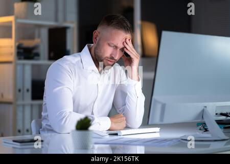 Stressful Business Man Working Late On Laptop In Office Stock Photo