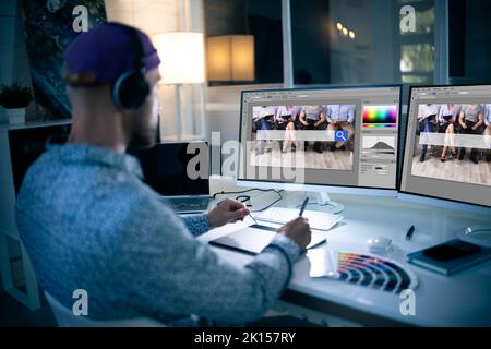 Graphic Designer Working Late At Night In Office Stock Photo