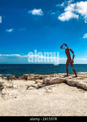Beautiful scenery of Playa de l'Ampolla beach and sea with a statue in Moraira, East Spain Stock Photo