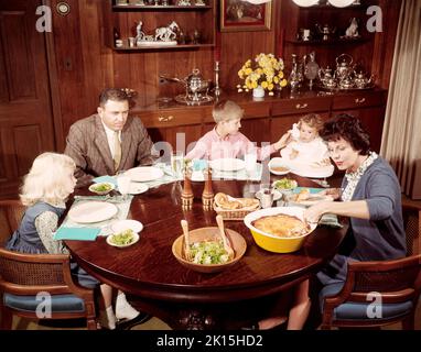 An american family sitting down for dinner. Picture taken in 1957. Stock Photo