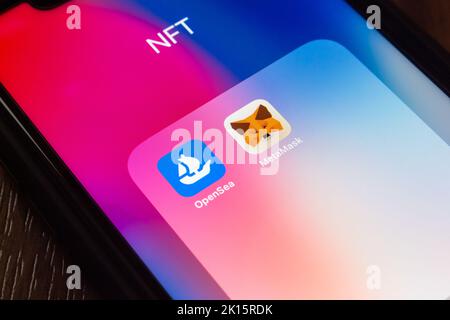 Vancouver, CANADA - Sep 11 2022 : OpenSea and MetaMask icons on an iPhone on wooden table. NFT digital art platform and Web3 Dapps concept. Stock Photo