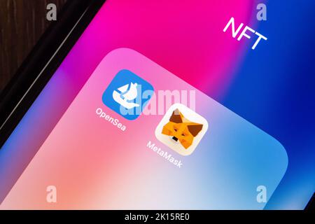 Vancouver, CANADA - Sep 11 2022 : OpenSea and MetaMask icons on an iPhone on wooden table. NFT digital art platform and Web3 Dapps concept. Stock Photo