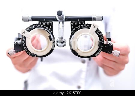 From above of crop unrecognizable ophthalmologist with optical trail lens frame standing in modern optic office Stock Photo