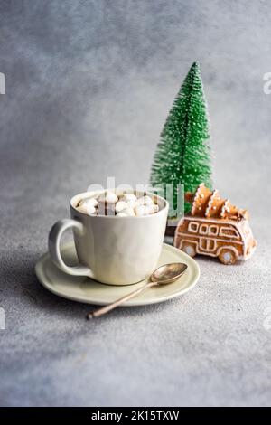 Mug with hot chocolate and mini marshmallows with spices on background with christmas decorations Stock Photo