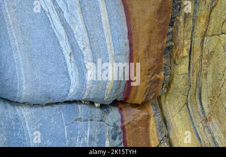 Fragment of rough surface of shabby blue painted rocky wall with scratches and cracks as textured background Stock Photo