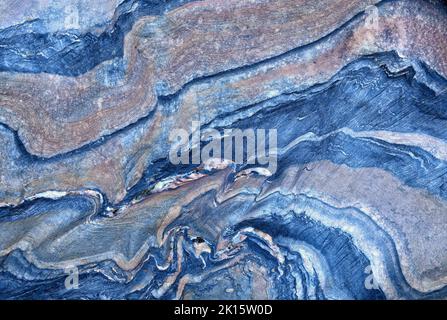 Textured background of smooth blue metamorphic stone with wavy abstract ornament in nature Stock Photo