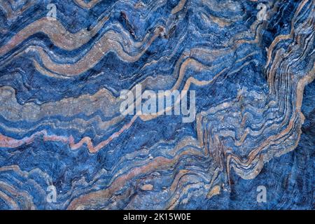 Textured background of smooth blue metamorphic stone with wavy abstract ornament in nature Stock Photo
