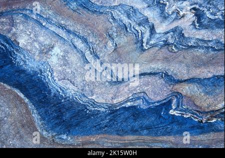 Textured background of smooth blue metamorphic stone with wavy abstract ornament in nature Stock Photo