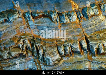 Textured background of smooth blue metamorphic stone with wavy abstract ornament in nature Stock Photo