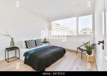Soft bed in light bedroom Stock Photo