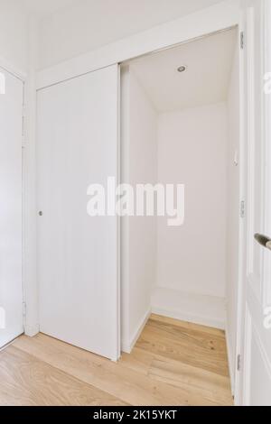 Interior of empty room with white walls and laminated floor and built in wardrobe case Stock Photo