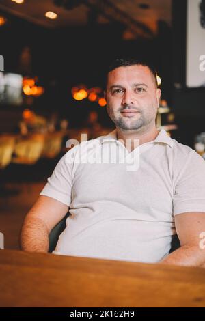Middle aged man sitting in a bar having breakfast Stock Photo
