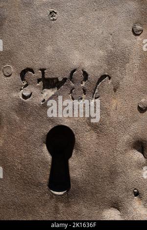 Close-up view of the entrance portal of the Monastery of Sant Cugat in Catalonia, Spain. Ancient medieval doorway, detail of keyhole. Front view. Stock Photo