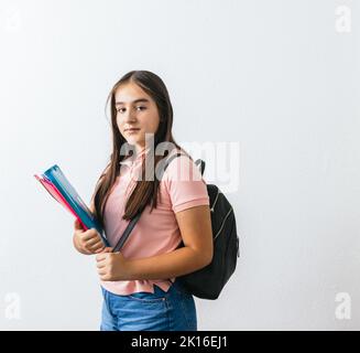 A Hispanic lady holding folders isolated on a white background Stock Photo