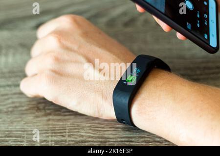 Close up shot of a man setting up a fitness wristband. Stock Photo