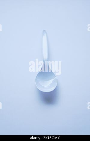 White disposable plastic spoon used for eating isolated on white Stock Photo