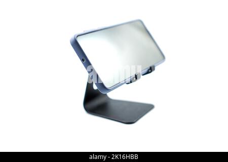 phone holder desk black aluminum metal with smartphone isolated on white background Stock Photo