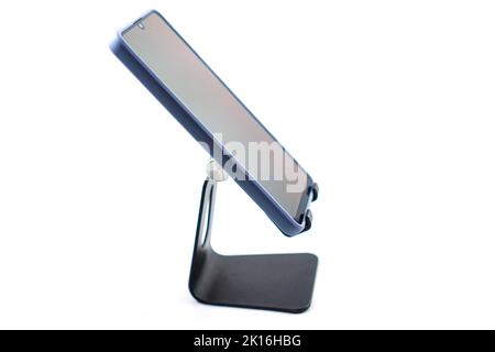 phone holder desk black aluminum metal with smartphone isolated on white background Stock Photo