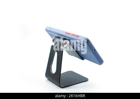 phone holder desk black aluminum metal with smartphone isolated on white background Stock Photo
