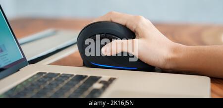 woman hand using computer ergonomic mouse, prevention wrist pain because working long time. De Quervain s tenosynovitis, Intersection Symptom, Carpal Stock Photo