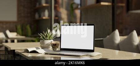 Notebook laptop white screen mockup, book and a cup of coffee on the table in comfortable coffee shop seating space. 3d rendering, 3d illustration Stock Photo