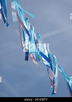 Vertical photo of a rope with blue colored ribbons from dark to light Stock Photo