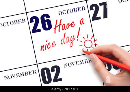 26th day of October. The hand writing the text Have a nice day and drawing the sun on the calendar date October 26. Save the date. Autumn month, day o Stock Photo